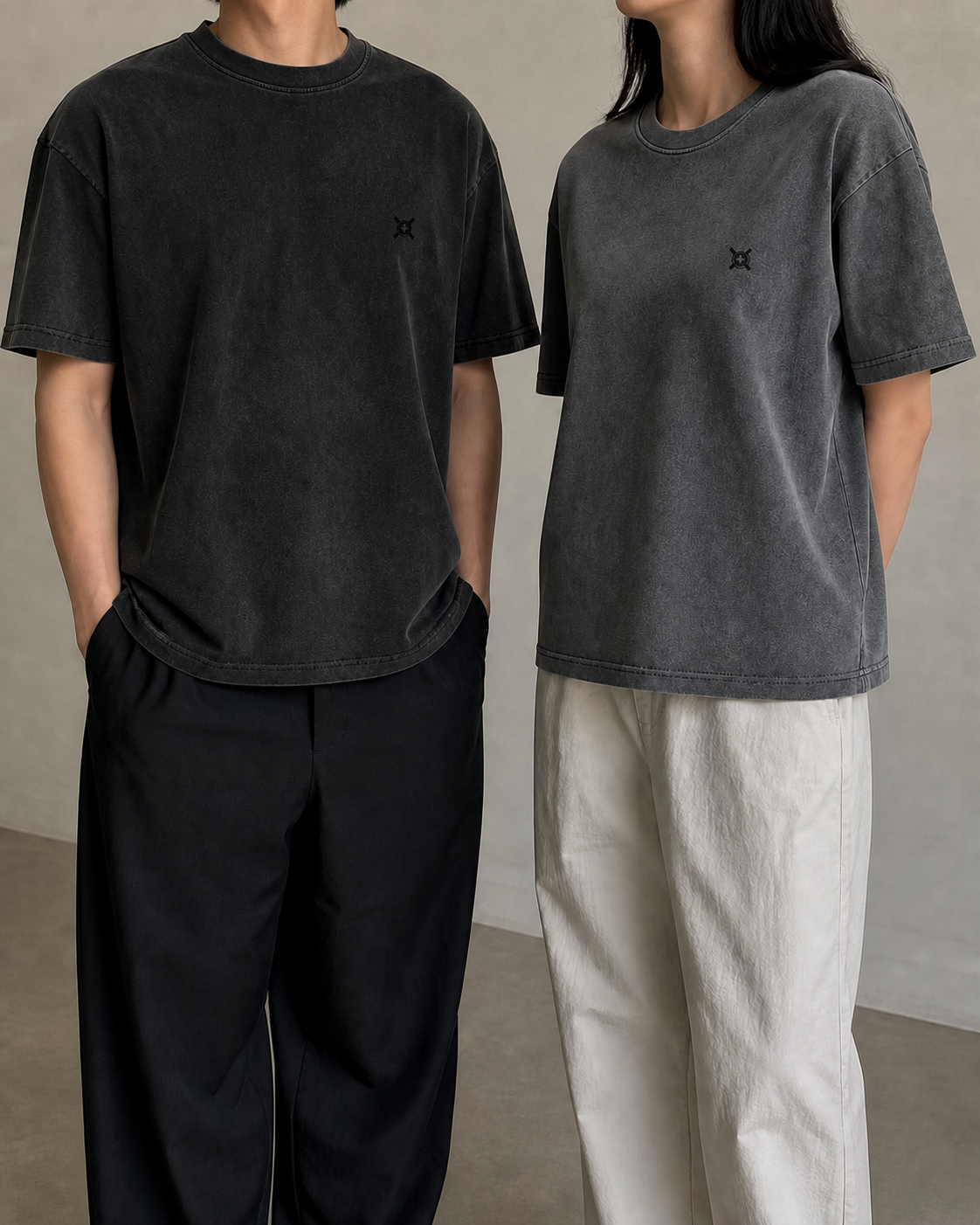 Digital upper-body fit concept showing a male model in FADED GRAPHITE and a female model in WASHED CHARCOAL HEAVYWEIGHT TEE